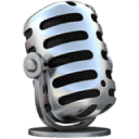 A vintage-style silver microphone with black grille openings, shown at a slight angle, sitting on a small round base.